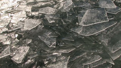 CU of overlapping shards of ice floating on water surface