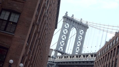 An establishing shot of New York City's Manhattan Bridge in DUMBO, Brooklyn. New York - May 1, 2016