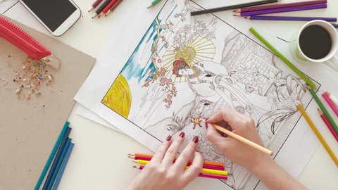 Top view of woman coloring in adult coloring book Stock Video
