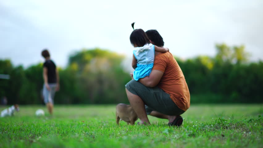 Asian happy family on green lawn