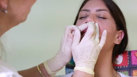 doctor lip massage with soothing cream after a silicone injection