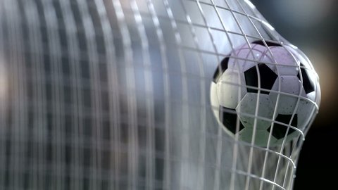 soccer ball in goal net with slowmotion. Slowmotion football ball in the net.