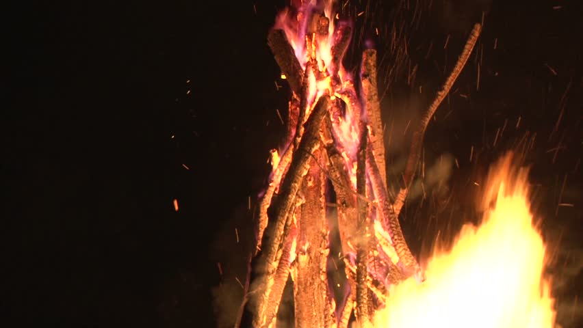 a large bright flame night fire, fire  sparks flying in  the night sky