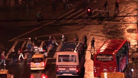 Medellin, Columbia, Circa 2016: Time Lapse of pedestrians walking across a cross walk at night in Medellin