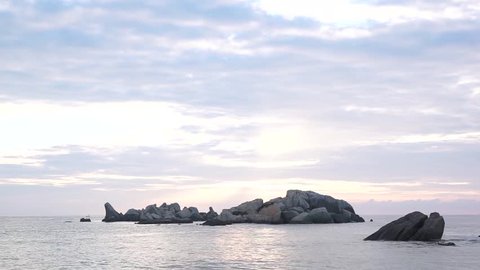 Sunrise moment with sleeping giant shaped rock formation at beautiful beach at Kijal Kemaman Terengganu Malaysia. HD footage.