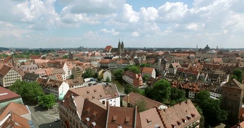 NUREMBERG, GERMANY June 6, 2016: The old city of Nuremberg is filmed in an aerial shot. The camera flies over the river Pregnitz and ends at the church Lorenz.
