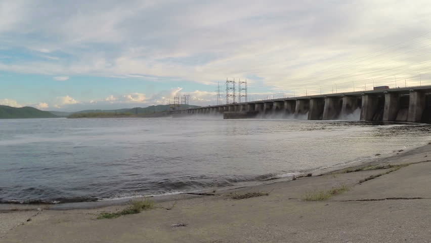 The young woman and two children look at hydroelectric power station. Slow motion

