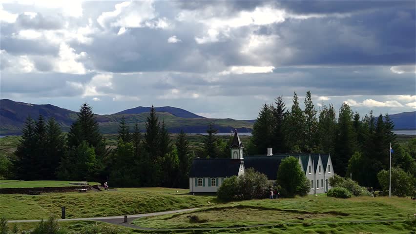 Dramatic shot of famous Pingvellir (Thingvellir) National Park, Iceland. Footage of white church in Pingvellir NP. Dramatic clouds over typical icelandic white church.
