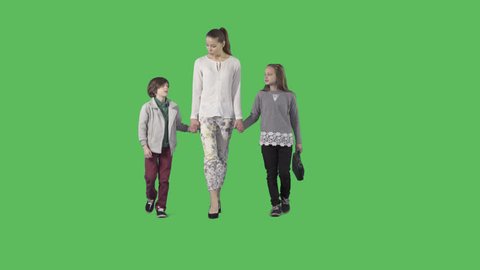 Young beautiful mother with two attractive children are walking at the camera. Camera is static. Lens 85 mm. Footage with alpha channel. File format - .mov, codec PNG+Alpha