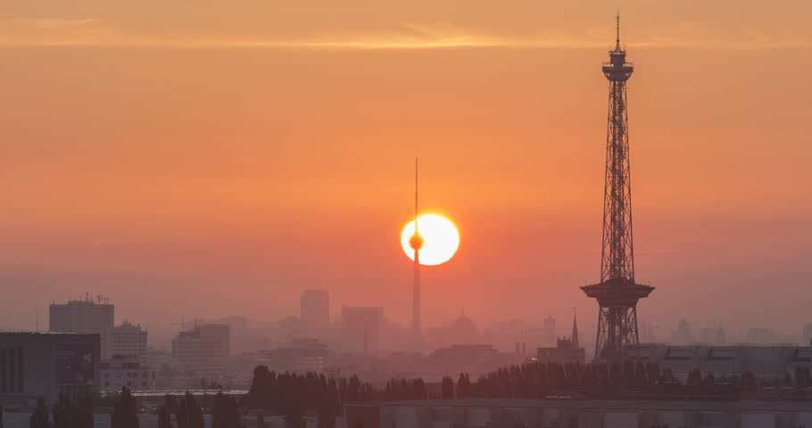 BERLIN, GERMANY: Sunrise in front of the silhouette of Berlin with the most famous towers and buildings. Time lapse view in 4K.