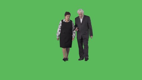 Senior man & woman in black clothes are walking at the camera and discussing. Camera is static. Lens 85 mm. Footage with alpha channel. File format - .mov, codec PNG+Alpha
