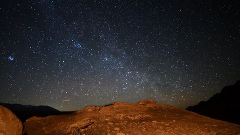 Astrophotography Time Lapse with zoom out motion of star trails over Native American petroglyphs in Eastern Sierra, California