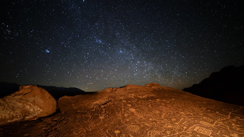Astrophotography Time Lapse of starry sky over Native American petroglyphs in Eastern Sierra, California -More Sky-