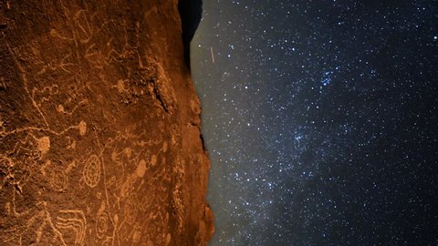 Astrophotography Time Lapse with pan motion of star trails over Native American petroglyphs in Eastern Sierra, California -Vertical Shot-