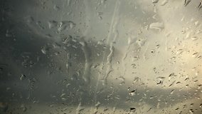 Raindrops on a window (close-up; 4K)