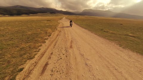 Motorcycle on a hot desert road. To be freee.  Aerial drone video. N.
Video about engines, solo journey, loneliness, drive, desire for freedom, escape, passion, discovery, drivers, bikers.