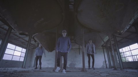Video of active young group dancing choreography in an abandoned building.