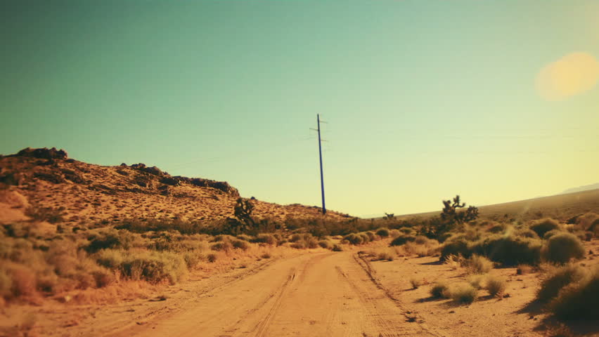 Driving on a Dirt Road in the Hot Desert