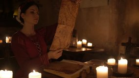 Medieval woman reading mysterious book in ancient castle interior in 4K UHD video.