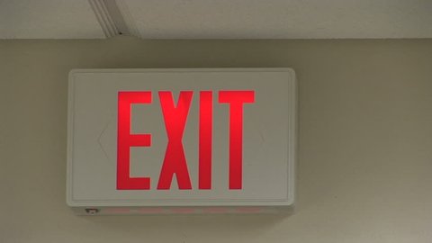 Zoom out shot of a glowing exit sign in an office in Scottsdale, Arizona