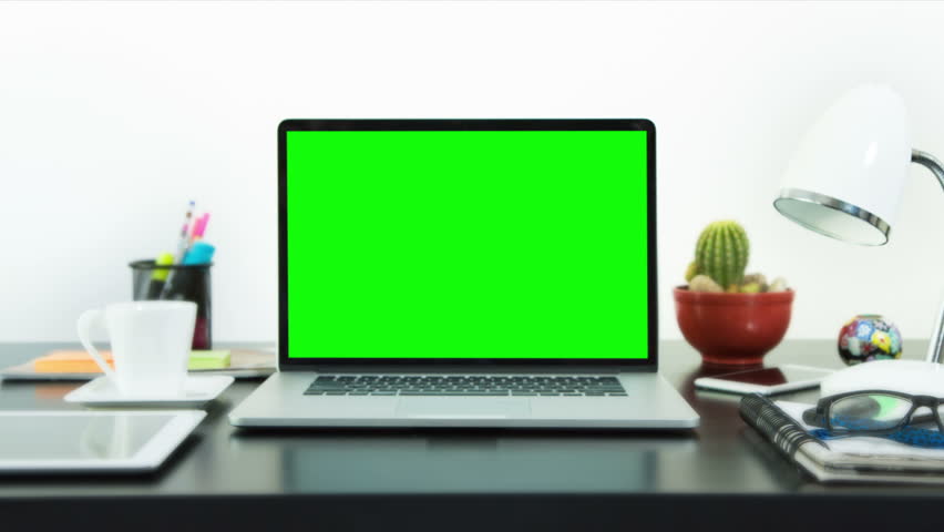 Black desk with a laptop, cell phone and digital tablet. Chroma key. Perfect to put your own images or videos. Track with perspective corner pin.  Royalty-Free Stock Footage #17421160