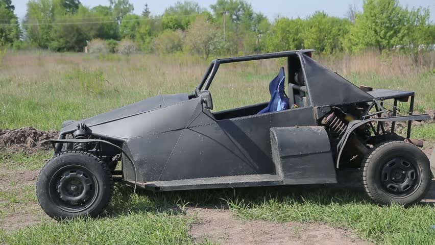 Man in helmet sits in the buggy.