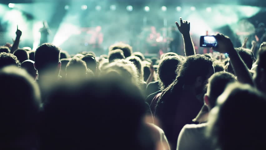 Iconic night rock concert front row crowd cheering slomo 100p.Night rock concert.People cheer move lift and clap their hands in unison against the strobing stage lights. Royalty-Free Stock Footage #17430769