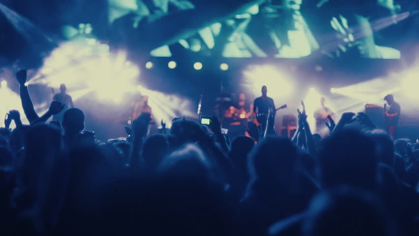 Iconic night rock concert front row crowd cheering hands in air slomo 100p.Night rock concert.People cheer move lift and clap their hands in unison against the strobing stage lights. Royalty-Free Stock Footage #17430772