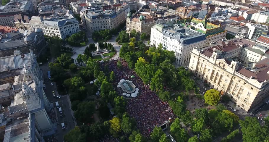 Drone footage shows aerial view of packed SzabadsÃ¡g tÃ©r or Freedom square in Budapest with thousands of people watching a football match. | Shutterstock HD Video #17430868