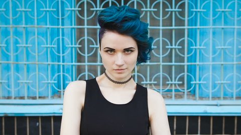Street punk or hipster girl with blue dyed hair.