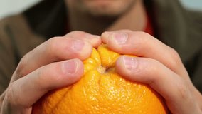 Big orange in human hands