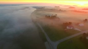 Mystical foggy country landscape with river, farms and homes,aerial view.
