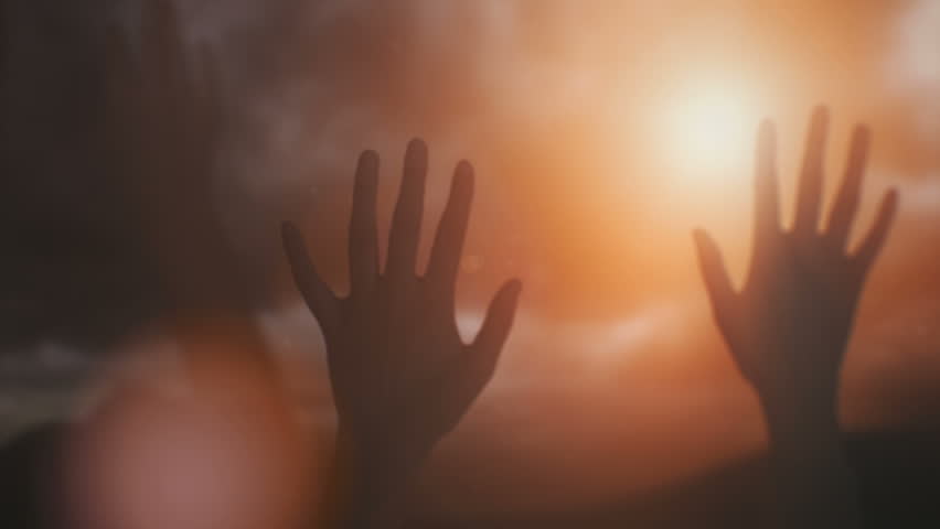 Silhouettes of hands raised in worship with sunlight. Royalty-Free Stock Footage #17460964