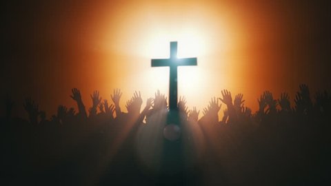 Silhouettes of hands raised in worship with Cross and Dove .
