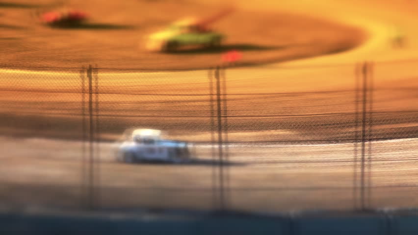 Cars Racing Around Dirt Track
