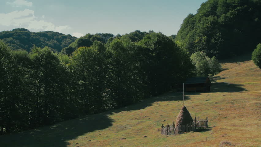 Carpathians landscape with rocks, wooded hills and meadows.