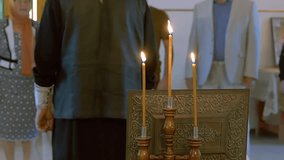priest in the Russian Orthodox Church is back lit prayer candles slow motion video