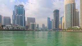 Sailing on Boat at Dubai Jumeira Marina video 4k. Skyscrapers modern buildings Travel tourism Real Estate business in United Arab Emirates 