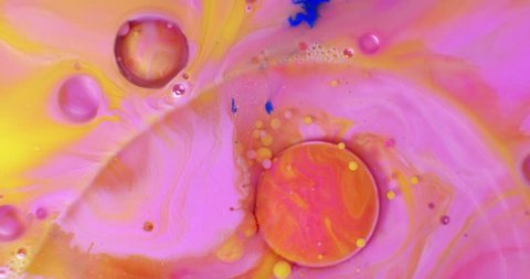 Color drops floating in oil and water over a colorful underground with oil painting effect.