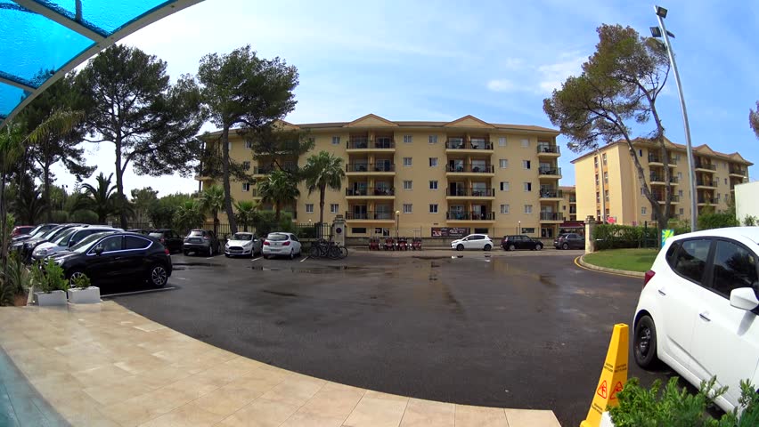Car parking at the entrance of luxury hotel lobby, sun after rain, Majorca, Spain