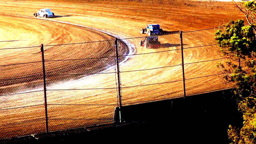Cars Racing Around Dirt Track