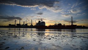 Video of petrochemical plant in morning time with reflection over the river site in Thailand