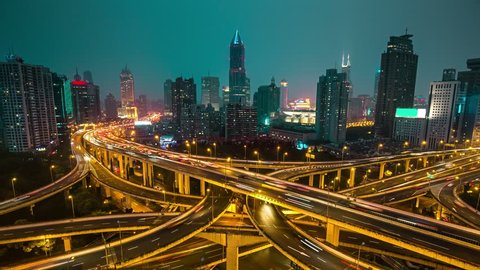 Famous highway intersection in Shanghai, China. Many intersecting highways with fast moving traffic. Time lapse.
