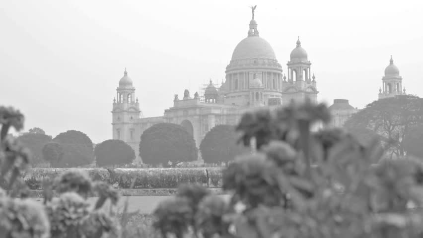 Victoria Memorial, Kolkata , Calcutta, West Bengal, India. A Historical Monument of Indian Architecture. Built between 1906 and 1921. Beautiful flowers in foreground - stock footage. 