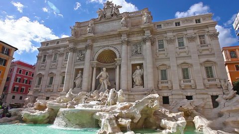Daily real time of tourists and people walking next to the Trevi Fountain in a sunny day with clouds, one of the most famous fountain in the world. Rome, Lazio, Italy. 
