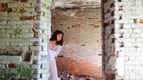 girl in a ball gown among the ruins of antiquity. white clothes on a young girl
