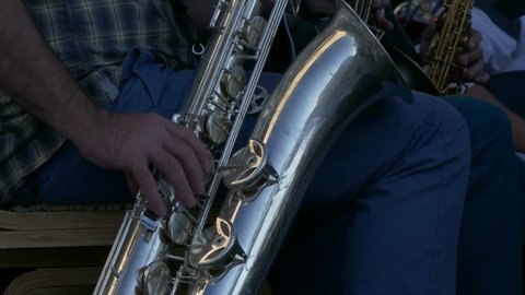 Ungraded: Saxophonist Playing / Sax Player / Orchestra musician. Man playing saxophone in jazz orchestra. Source: Lumix DMC, ungraded H.264 from camera without re-encoding. (av25423u)