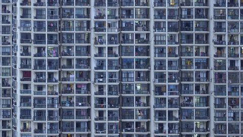 Timelapse of apartment windows at dusk to night. Nighttime time lapse of illuminated building windows at night with people living in flats with balcony in Shanghai, China.