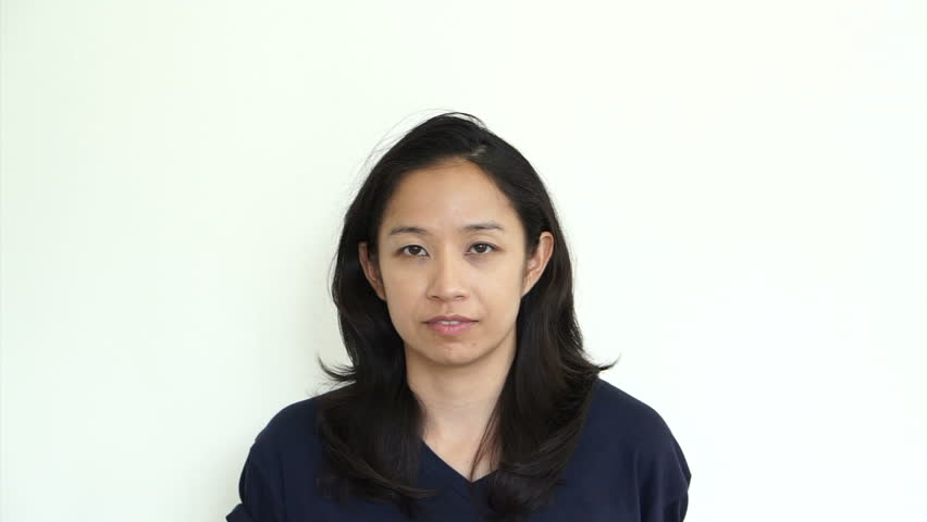 Asian girl with hat hiding face and smile