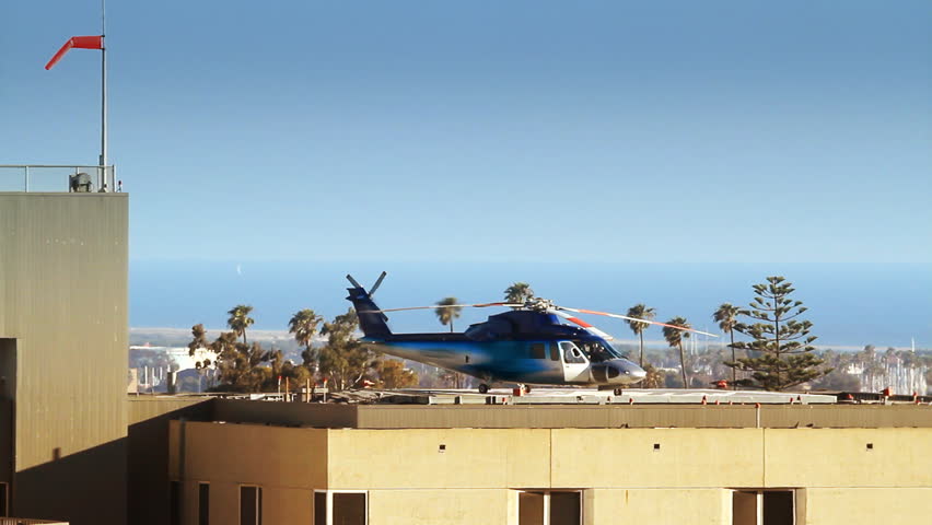 Helicopter Preparing for Takeoff from Helipad